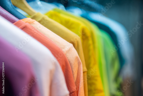 Rainbow Row of Vibrant T-Shirts on Rack with Bokeh