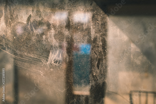 Bild auf Leinwand Dirty, dusty, and scratched window glass surface against a dim interior backgrou