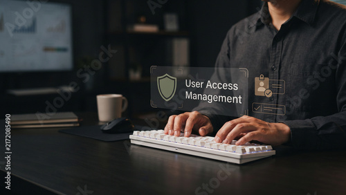 Man typing on keyboard with user access management text and security icons interface, access control, permission management