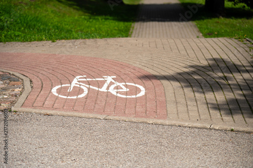 Canvastavla Bike path sign shows direction for cyclists in a park in daylight