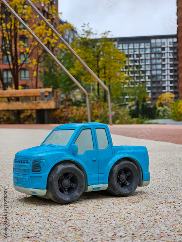 Canvastavla Blue plastic toy truck sits on gravel path