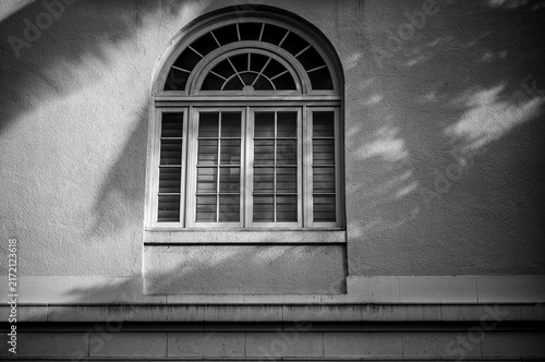 Arched Picture Window in Sunlight with Shadows.