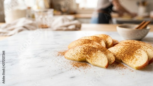 Fresh Apple Slices Sprinkled with Cinnamon on Marble Countertop
