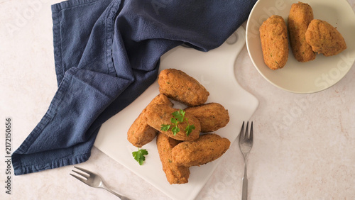 Cuadro en lienzo Crispy fried croquettes on a white board