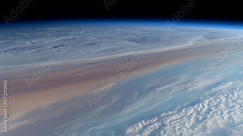 A breathtaking perspective of Earth captured from orbit showcases vibrant clouds blending with the blue ocean, illuminated by the soft hues of dawn. The scene is filled with wonder and tranquility