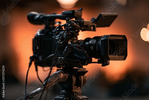 Naklejka Professional video camera on tripod, ready for action