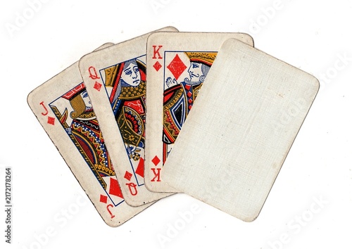 Photography A hand of grubby old vintage playing cards with one blank card for text or copy isolated on a white background