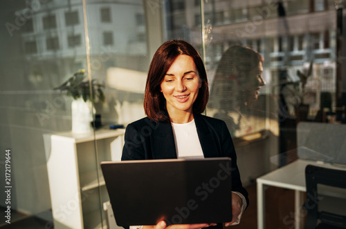 Happy businesswoman smiling while working on a laptop