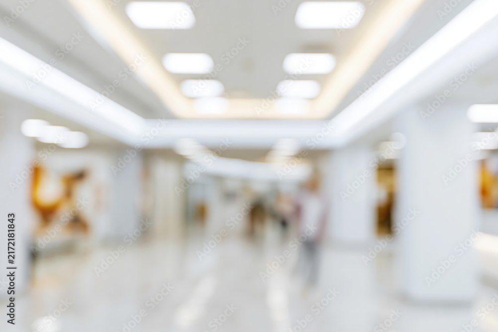 Naklejka premium The Blurred Shopping Mall Corridor in Bright Modern Interior with Soft Lighting