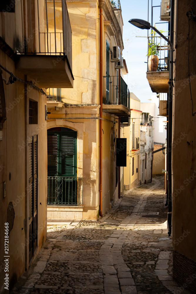 Fototapeta premium Noto, Italy; October 1, 2026: Narrow, colorful streets with staircases in the old part of the city.