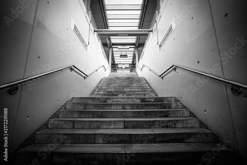 Empty staircase in a German train station, symbolizing urban structure, movement and architectural perspective in modern public spaces.
