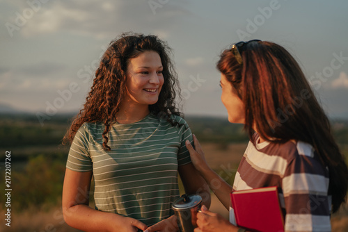 Mother and daughter having a meaningful conversation outdoors