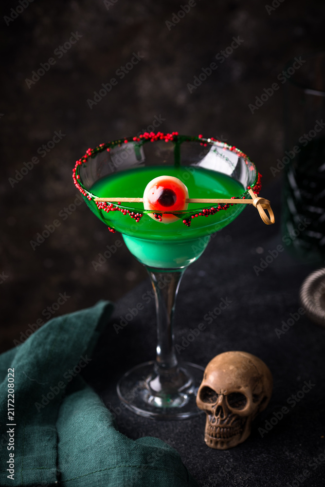 Fototapeta premium Spooky green Halloween monster cocktail with eyeball