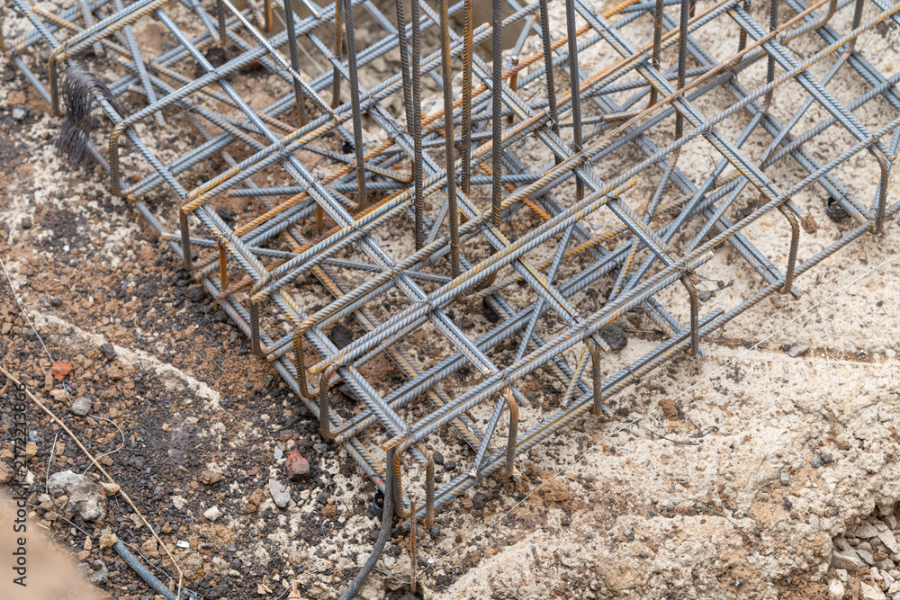 Obraz premium Construction site reveals intricate detail of excavation pit and steel reinforcement ready for new foundation laying