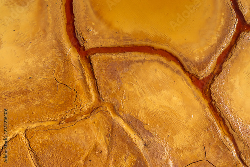 Mineral-Rich Cracked Soil with Orange Pools in Mazarrón Mines, Murcia, Spain