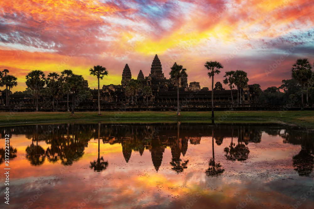 Fototapeta premium Famous viiew of Angkor wat temple,dramatic sky at sunrise with water reflections, Siem Reap, Cambodia
