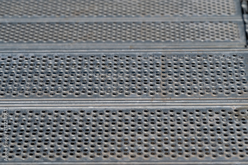 Bild auf Leinwand Metal steps glimmer under sunlight showcasing textured surfaces and intricate pa