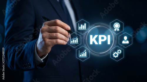 Businessman holding pen near digital KPI performance icons