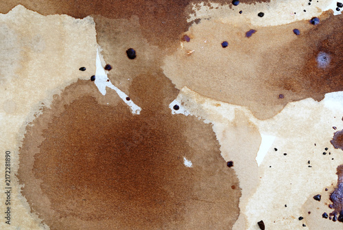 Close-up abstract photograph of layered brown coffee-like stains and natural liquid patterns on textured paper. Abstract Coffee Stain Texture on Paper. Rustic Brown Artistic Background.