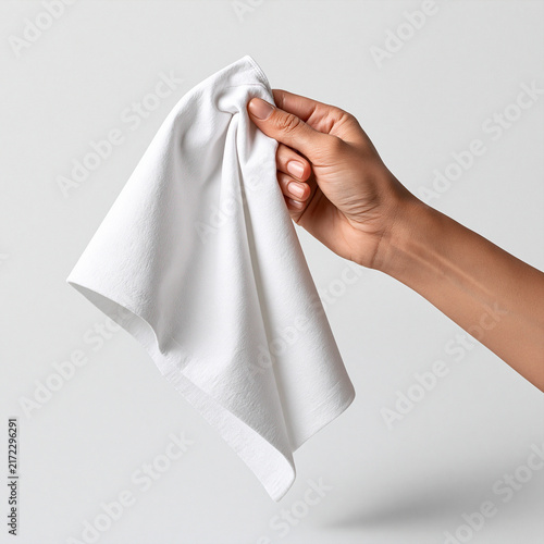 Hand Holding White Cloth: A close-up shot of a hand gently holding a crumpled white fabric, ready for cleaning or a craft.