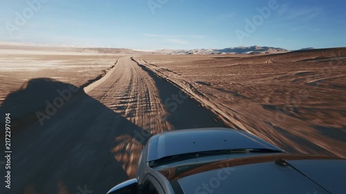 Offroad SUV Pick Up Truck driving through Campo de Piedra Pomez in Catamarca Argentina Front Hood POV sunrise - Drone flying, Aerial view
