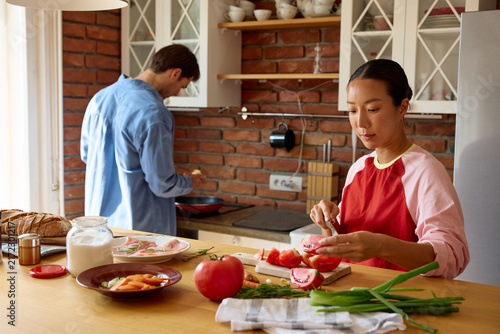 Man and woman prepare meal in the kitchen