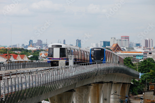Skytrains Travel on an elevated track in Urban Area During Afternoon