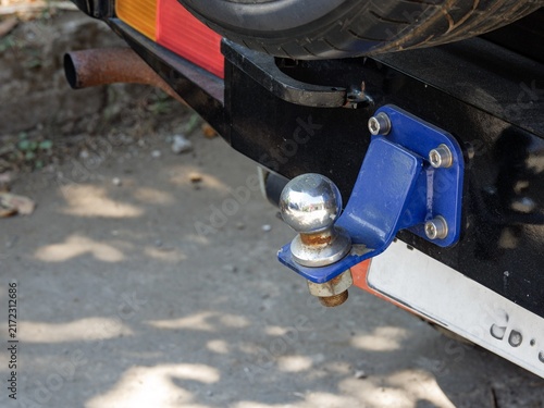 Rear trailer tow hitch ball assembly mounted on an offroad vehicle bumper for towing equipment or trailers.
