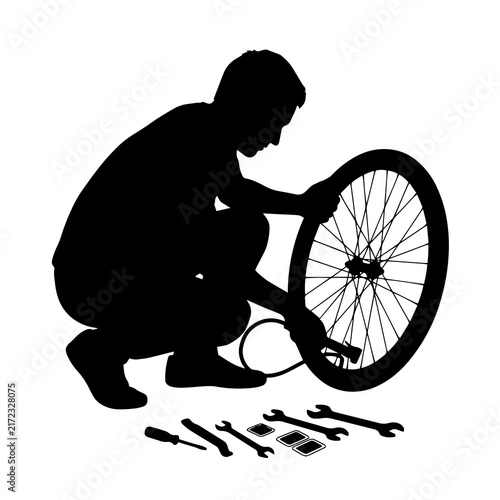 Mechanic pumping bicycle wheel tire with pump and repair tools silhouette