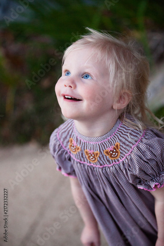portrait of a little girl looking up in awe