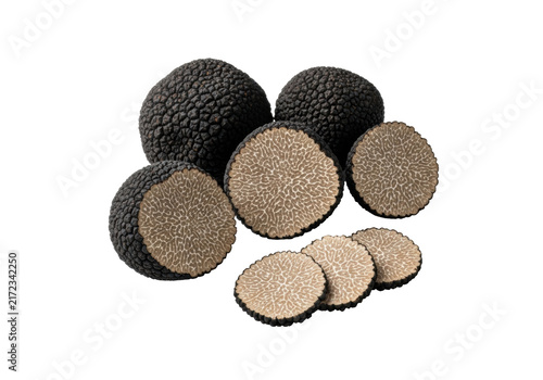 A sophisticated flat lay of whole, sliced, and halved black truffles on a transparent background with copy space, concept of luxury and culinary excellence