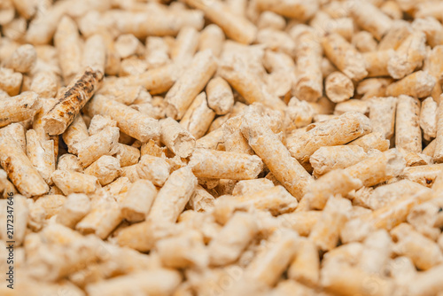 soft focus, texture Wood pellets are stacked together in  large pile at  storage site during daylight hours. soft focus.  pellets made from compressed wood fibers. 