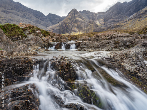 A beautiful waterfall with mountains in the background