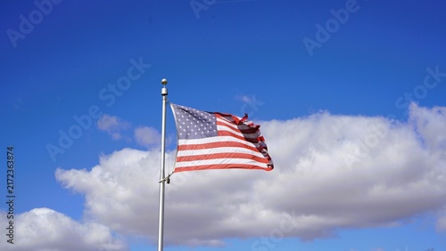 american flag against blue sky