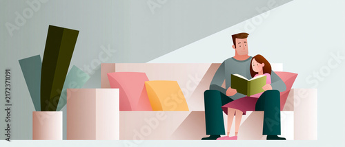 Father reading a book to daughter in a cozy living room setting  