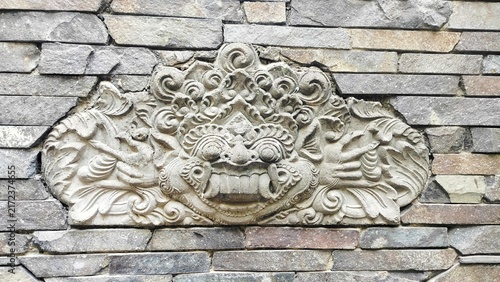 Картината върху платно traditional bali stone carving relief sculpture on brick wall