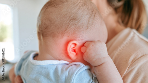 Unrecognizable Baby with Ear Ache Marker Reaching Hand to Head