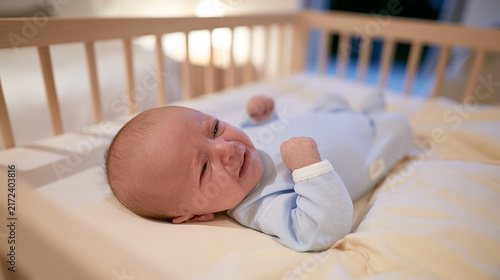 Nighttime Crying and Disrupted Sleep Concept with Blurred Infant in a Crib