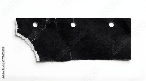 Torn black paper strip with hole punches isolated on white background