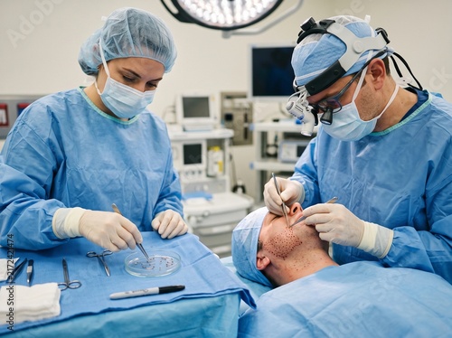 Surgeons Performing Specialized Facial Procedure in Hospital Operating Room