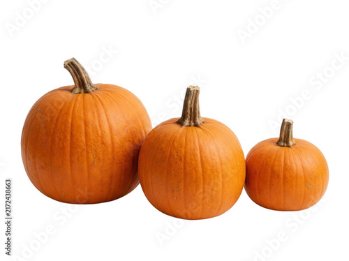 Three orange pumpkins of various sizes isolated on transparent background