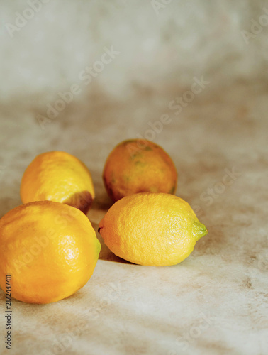 Fresh Yellow Lemons on Light Marble Surface