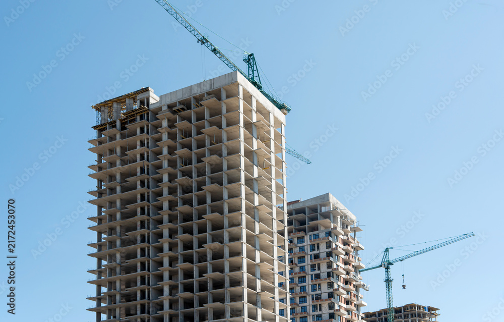 Fototapeta premium Concrete frame structure of unfinished high-rise buildings during modern urban development process