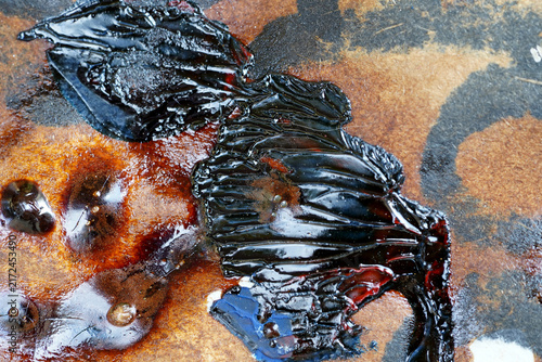 Abstract Black and Brown Paint Texture with Glossy Blue and Red Accents