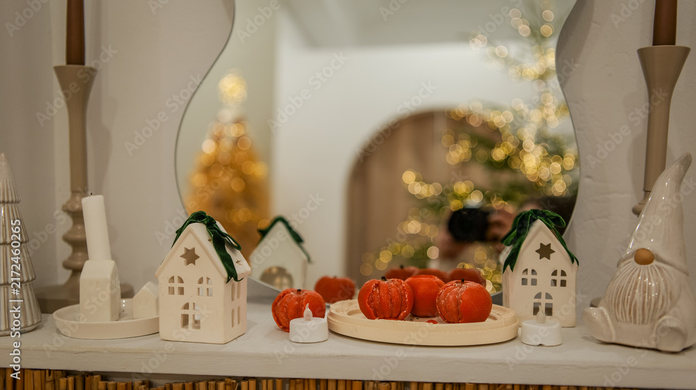 Obraz premium Cozy winter mantelpiece decor with festive Christmas tree and warm candlelight