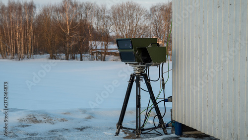 Картината върху платно In a picturesque snowy landscape nestled in a rural area, a sophisticated device has been carefully set up
