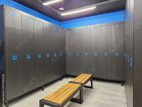 Quadro su tela Modern locker room with blue-lit storage and wooden bench in middle with electro