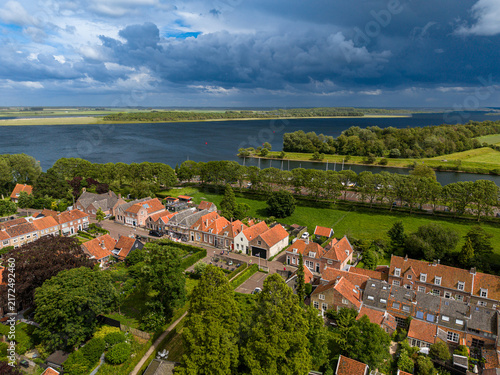 Canvas Print High angle wide horizontal aerial drone photograph of historic orange roofs, Lak