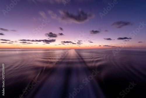 Canvastavla Travel and freedom, boat wake on ocean water during a peaceful sunset at sea