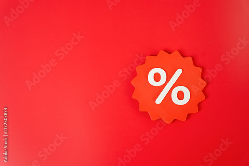 Percentage discount sticker on a red background. Sale and discount concept. Price reductions and special offers attract customers and increase purchase demand.